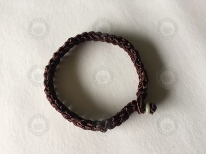 Brown bracelet with jade button and evil-evading knot