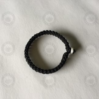 Black bracelet with jade button and evil- evading knot