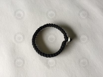 Black bracelet with jade button and evil- evading knot
